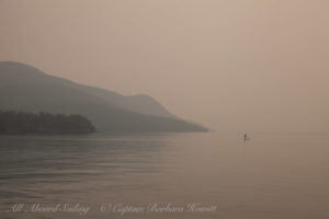 Paddle Boarder in sunset smoky haze